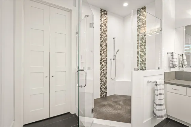 a large white kitchen with a sink dishwasher stove and white cabinets