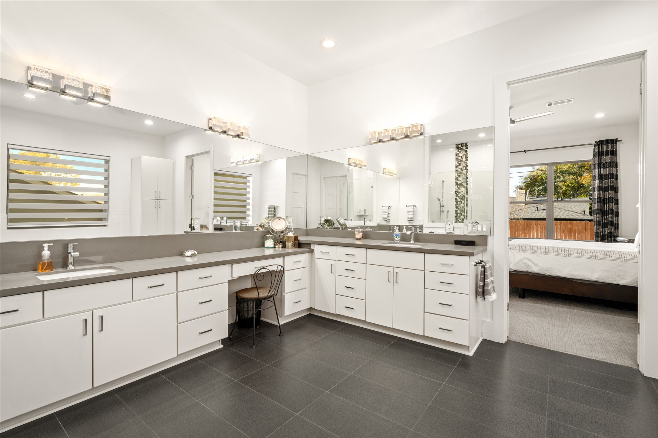 5706 Birdwood Road Houston, TX 77096 - Photo 26 of 50 Two walls of mirrors, designer sconces and so many drawers and cabinets to choose from for storage.