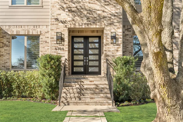 a front view of a house with a garden