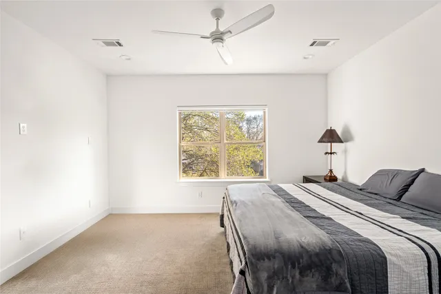 a bathroom with a sink a toilet and shower curtain