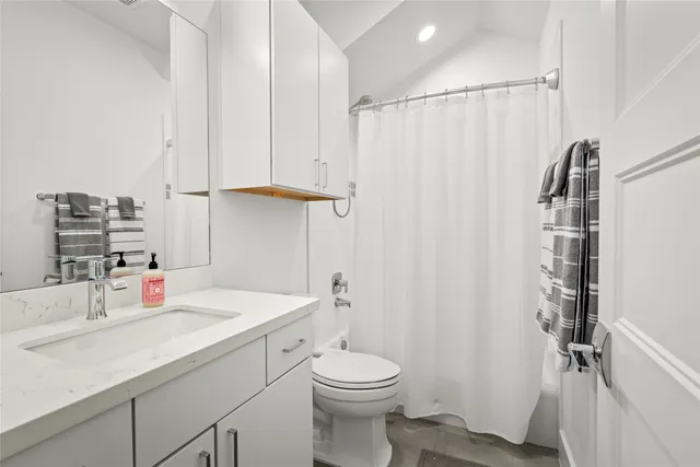 a spacious bedroom with a bed and a window