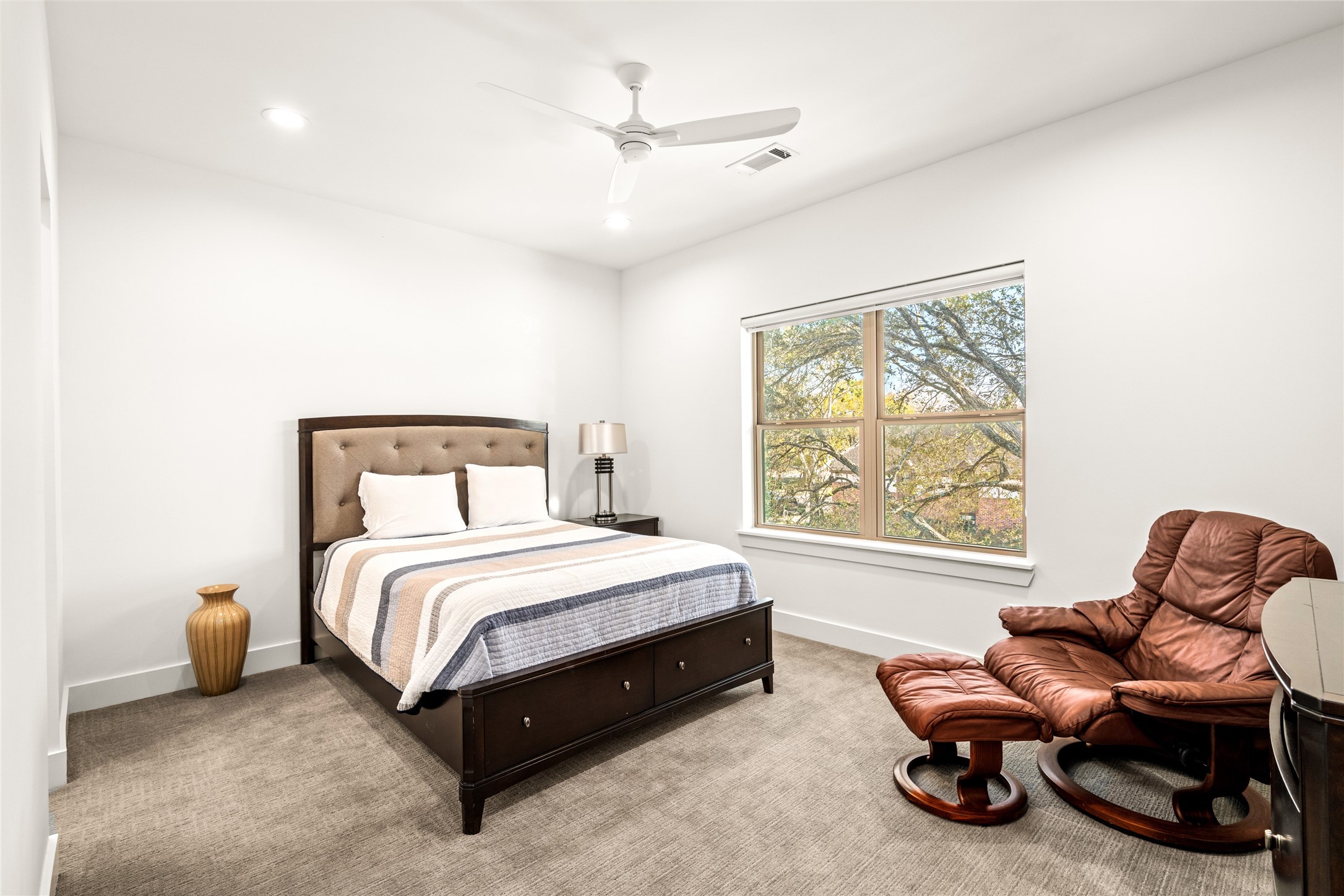 5706 Birdwood Road Houston, TX 77096 - Photo 32 of 50 The two other secondary bedrooms are located on the east side of the home. This is the front bedroom with large window, recessed lighting, carpet and ceiling fan.