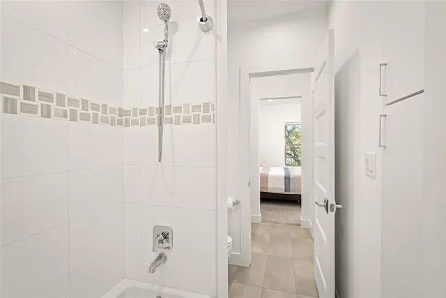 a large bed sitting in a bedroom next to a window