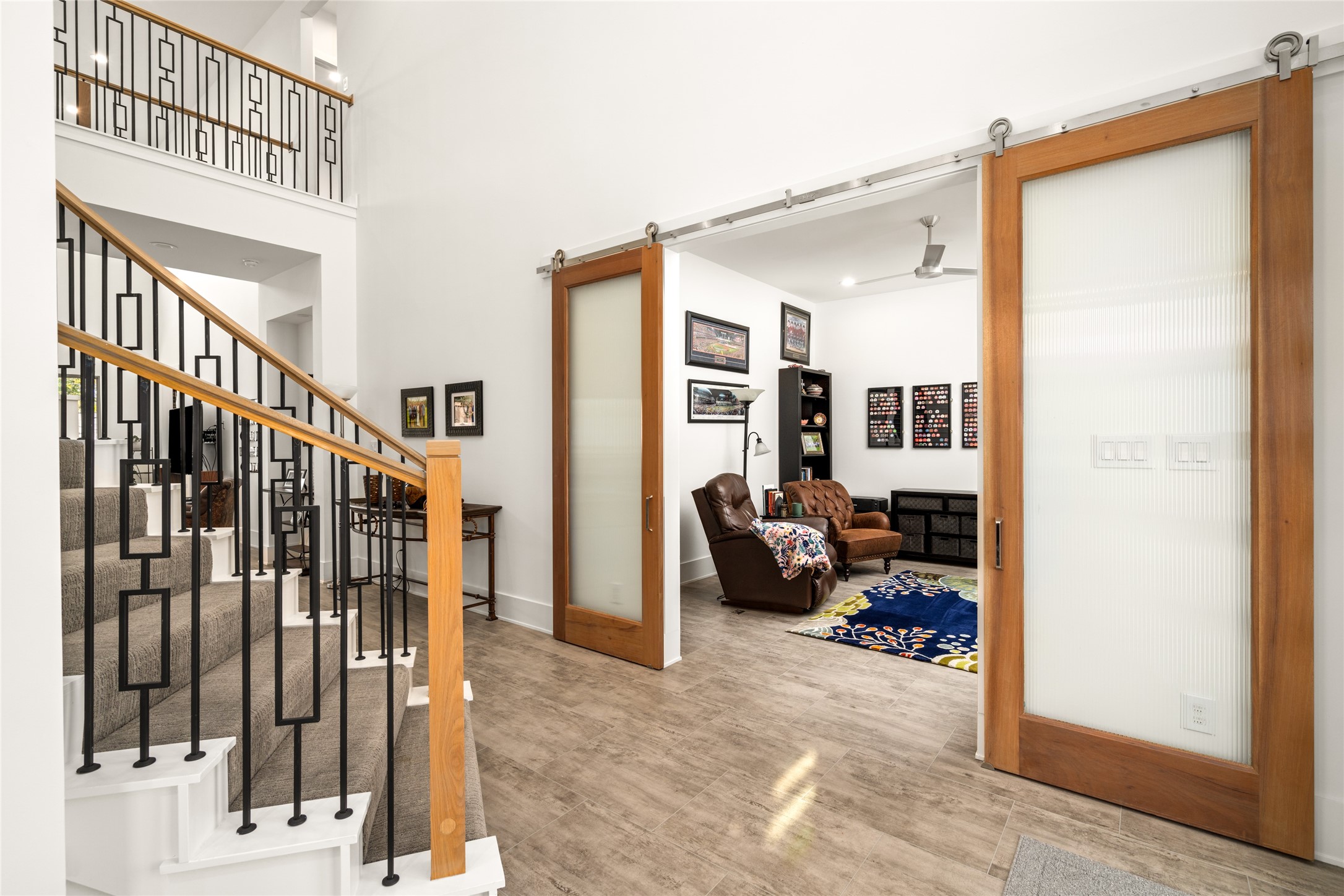 5706 Birdwood Road Houston, TX 77096 - Photo 6 of 50 A view of the living room with sliding doors for privacy, is directly adjacent to the 2 story entry which is washed in natural light from well placed windows above.