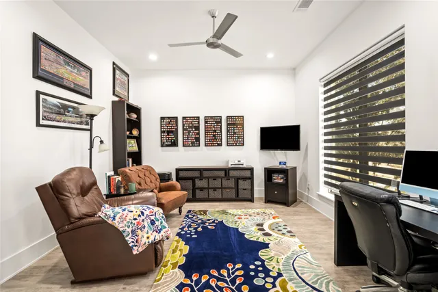 a living room with furniture and a piano