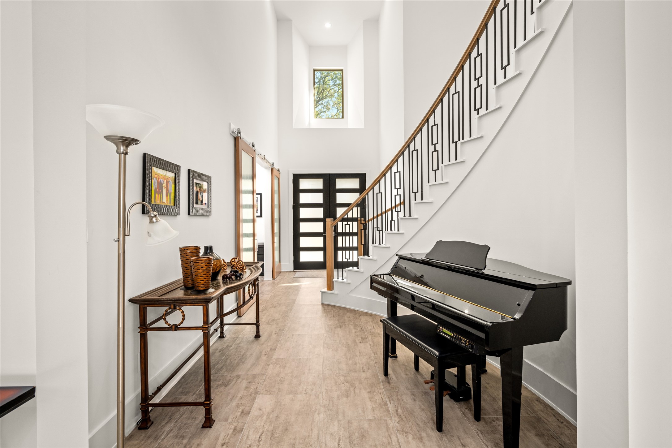 5706 Birdwood Road Houston, TX 77096 - Photo 8 of 50 Another perspective of the elegant 2-story foyer with a view to the clerestory window that brightens the space. The modern staircase has sleek railings and subtle design details.