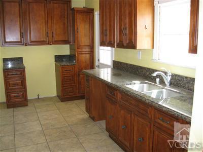 421 Acacia Road Santa Paula, CA 93060 - Photo 3 of 11 a kitchen with granite countertop a sink and a stove
