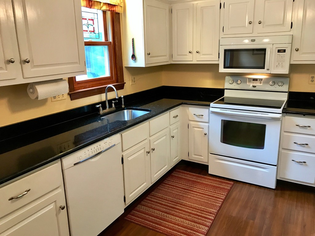 9 Green Valley Road Medway, MA 02053 - Photo 18 of 30 a kitchen with granite countertop white cabinets and white appliances