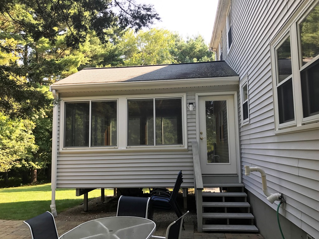 9 Green Valley Road Medway, MA 02053 - Photo 9 of 30 a view of a patio with table and chairs and floor to ceiling window