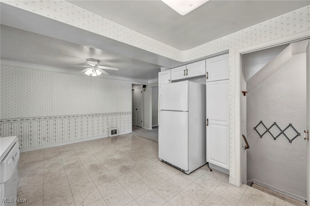 1711 Rush Road Wickliffe, OH 44092 - Photo 12 of 38 Kitchen with wallpapered walls, white appliances, white cabinetry, and a ceiling fan