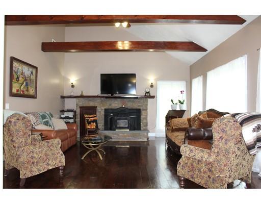 64 Middleboro Road Freetown, MA 02717 - Photo 11 of 30 a living room with furniture a flat screen tv and a fireplace