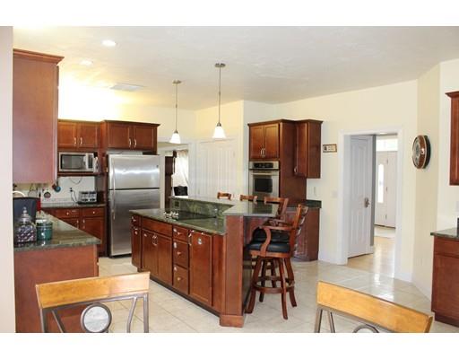 64 Middleboro Road Freetown, MA 02717 - Photo 3 of 30 a kitchen with stainless steel appliances kitchen island granite countertop a refrigerator and a stove