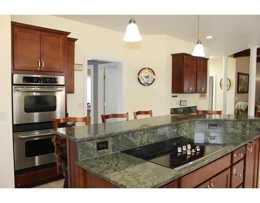 64 Middleboro Road Freetown, MA 02717 - Photo 6 of 30 a kitchen with kitchen island granite countertop a stove a sink and a microwave