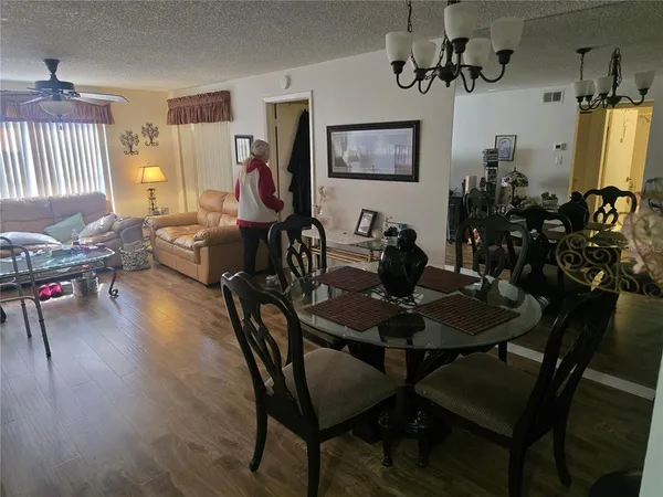 a dining room with furniture window and wooden floor