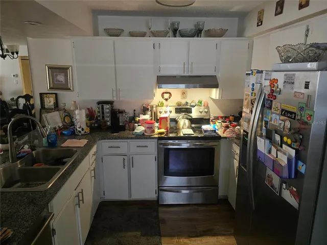 a kitchen with a sink stove and cabinets