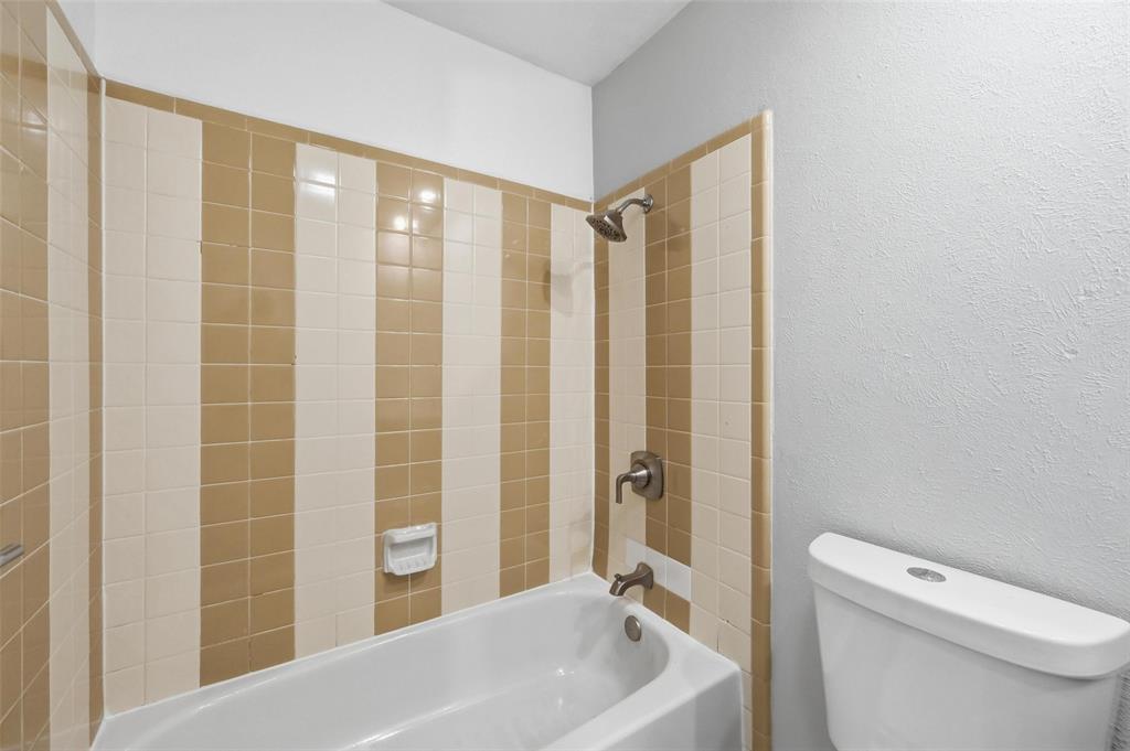 2102 Lewis Trail Grand Prairie, TX 75052 - Photo 15 of 33 a bathroom with a toilet a sink and shower