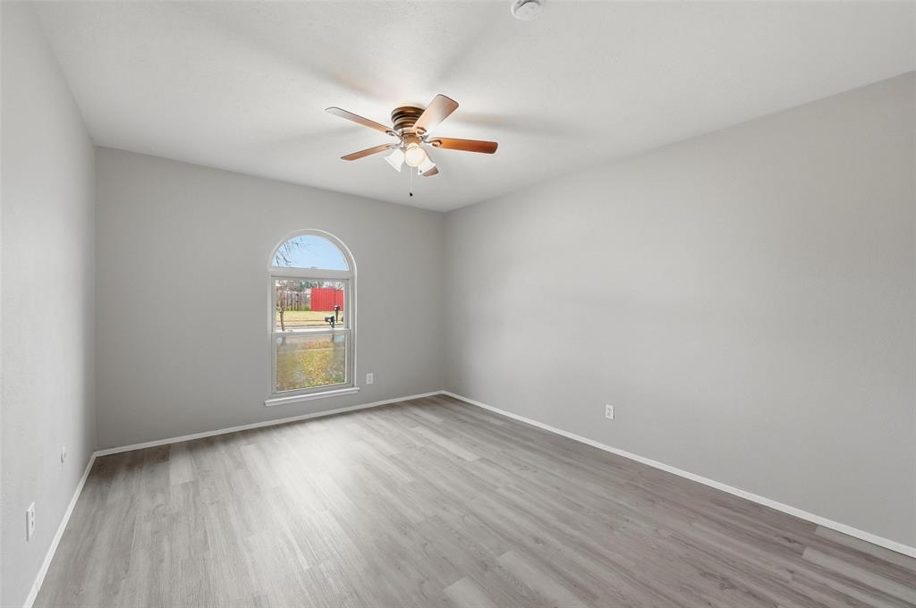 2102 Lewis Trail Grand Prairie, TX 75052 - Photo 19 of 33 wooden floor in an empty room with a window