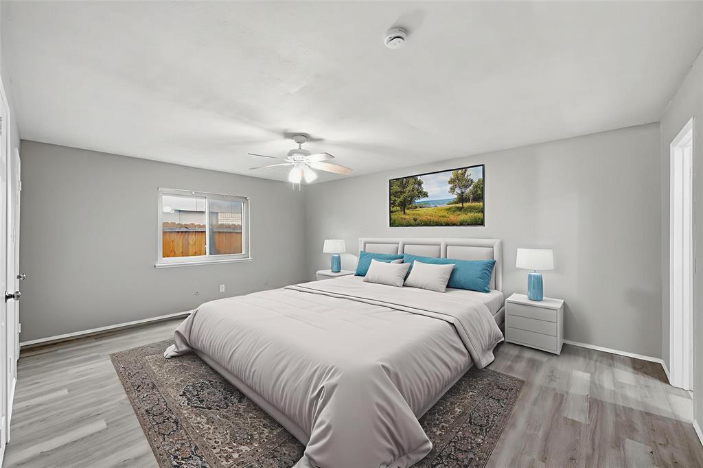 2102 Lewis Trail Grand Prairie, TX 75052 - Photo 21 of 33 a bedroom with a large bed and a chandelier