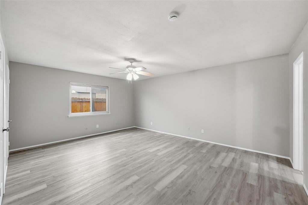 2102 Lewis Trail Grand Prairie, TX 75052 - Photo 22 of 33 a view of an empty room with wooden floor and a window