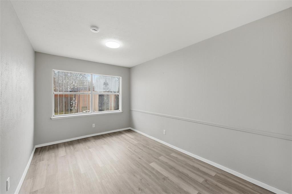 2102 Lewis Trail Grand Prairie, TX 75052 - Photo 6 of 33 a view of empty room with wooden floor and fan
