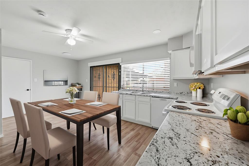 2102 Lewis Trail Grand Prairie, TX 75052 - Photo 8 of 33 a kitchen with stainless steel appliances kitchen island granite countertop a dining table chairs and white cabinets
