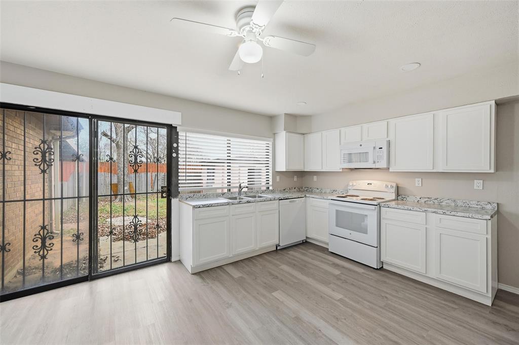 2102 Lewis Trail Grand Prairie, TX 75052 - Photo 10 of 33 a kitchen with appliances cabinets a sink and a stove