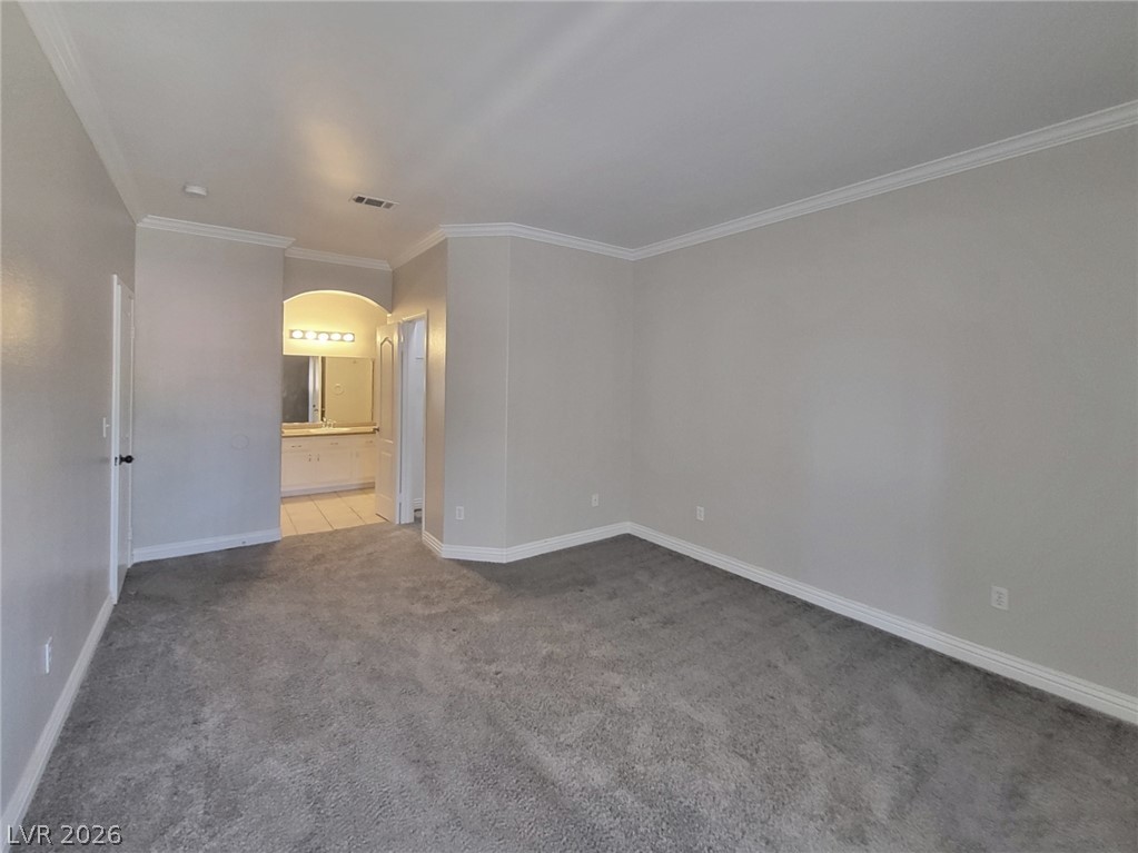 5525 West Flamingo Road, Unit 2040 Las Vegas, NV 89103 - Photo 9 of 15 A spacious chamber boasting plush carpeting and crown molding, leading to an adjoining well-appointed bath.