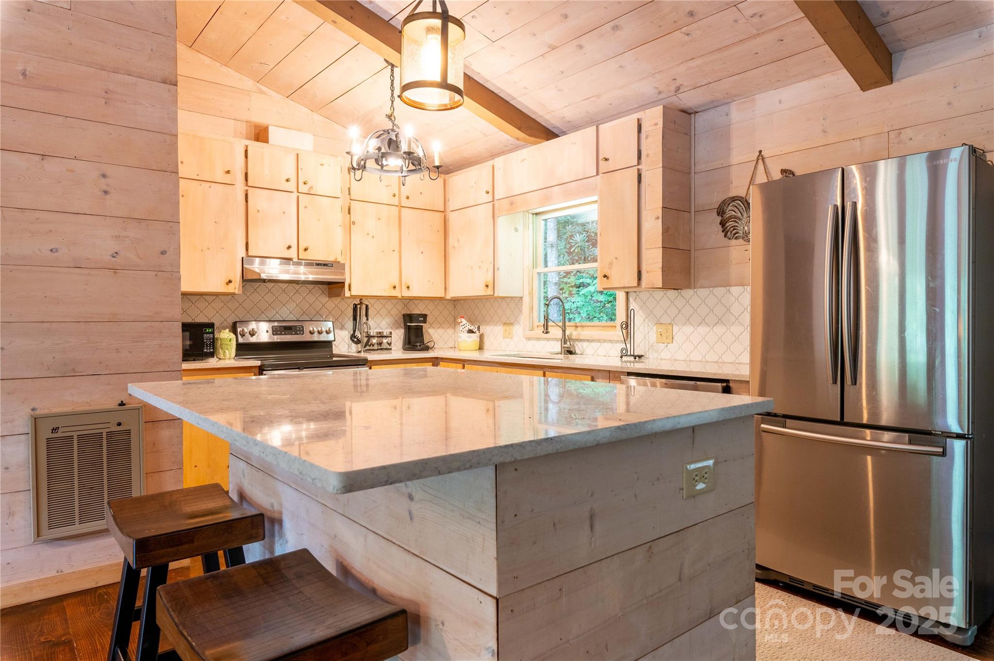 479 Big Ridge Road Burnsville, NC 28714 - Photo 11 of 40 a kitchen with kitchen island a large counter top space appliances and cabinets