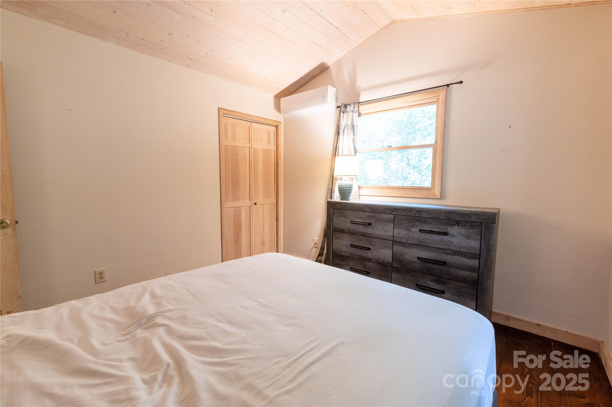479 Big Ridge Road Burnsville, NC 28714 - Photo 13 of 40 a bed sitting in a bedroom next to a window