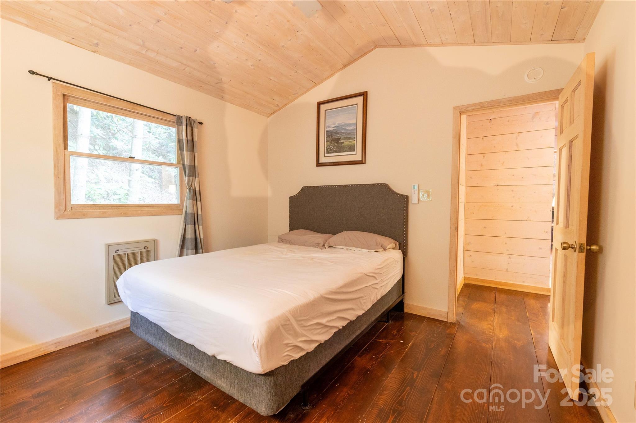 479 Big Ridge Road Burnsville, NC 28714 - Photo 15 of 40 a bedroom with a bed and a window