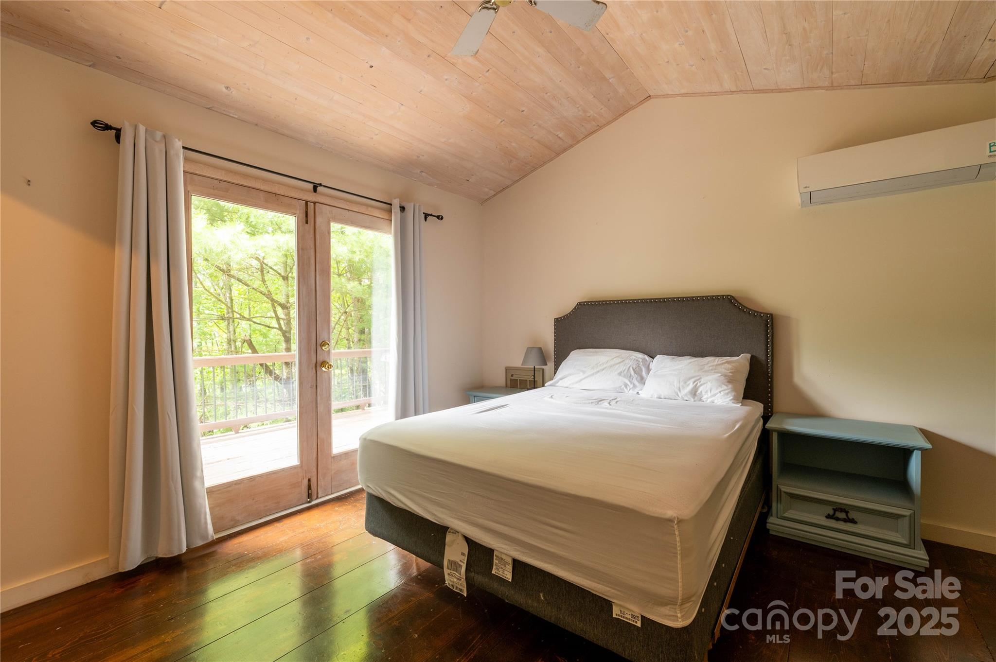 479 Big Ridge Road Burnsville, NC 28714 - Photo 19 of 40 a bedroom with a bed and a window