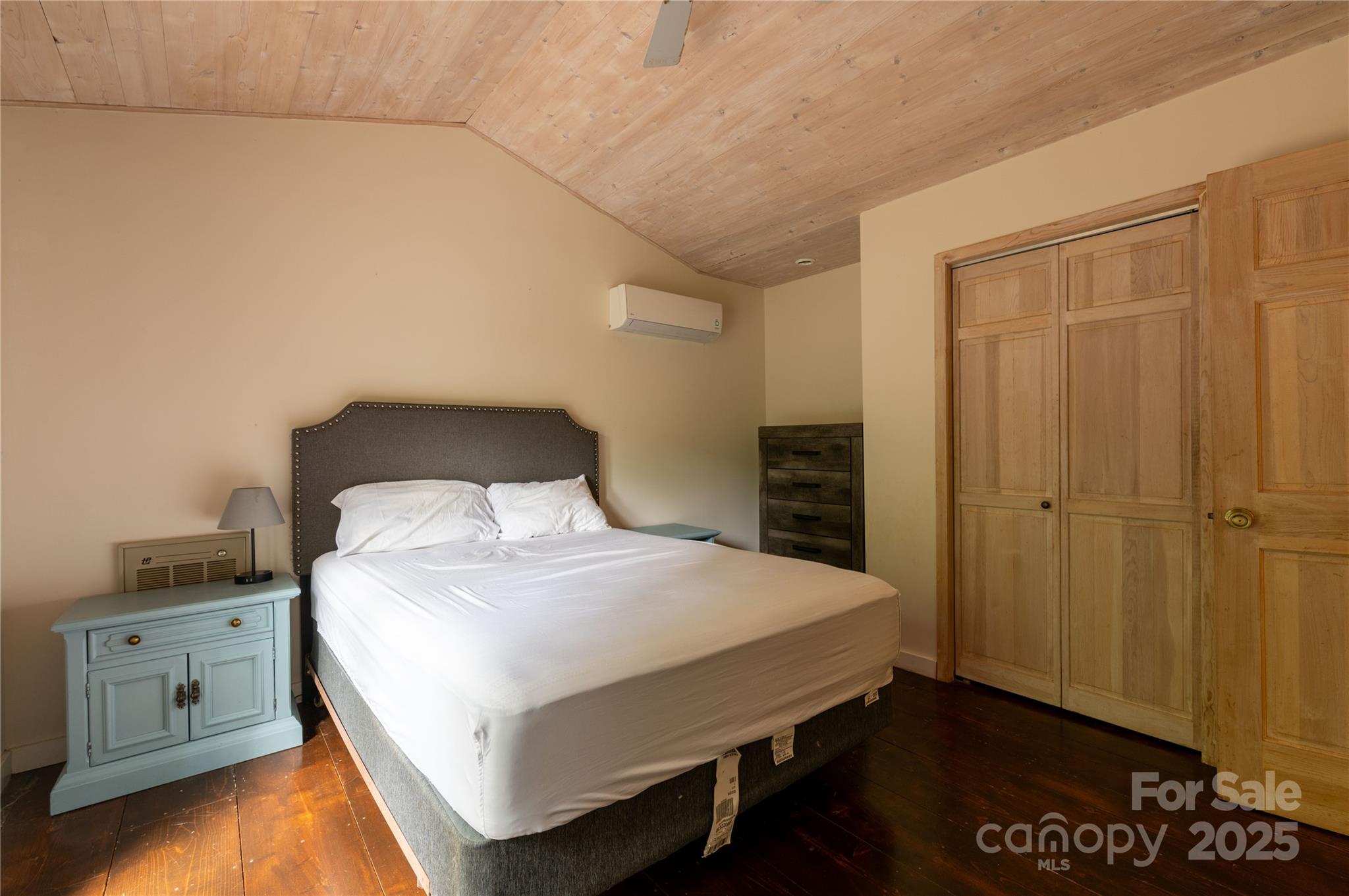 479 Big Ridge Road Burnsville, NC 28714 - Photo 20 of 40 a bedroom with a bed and a night stand