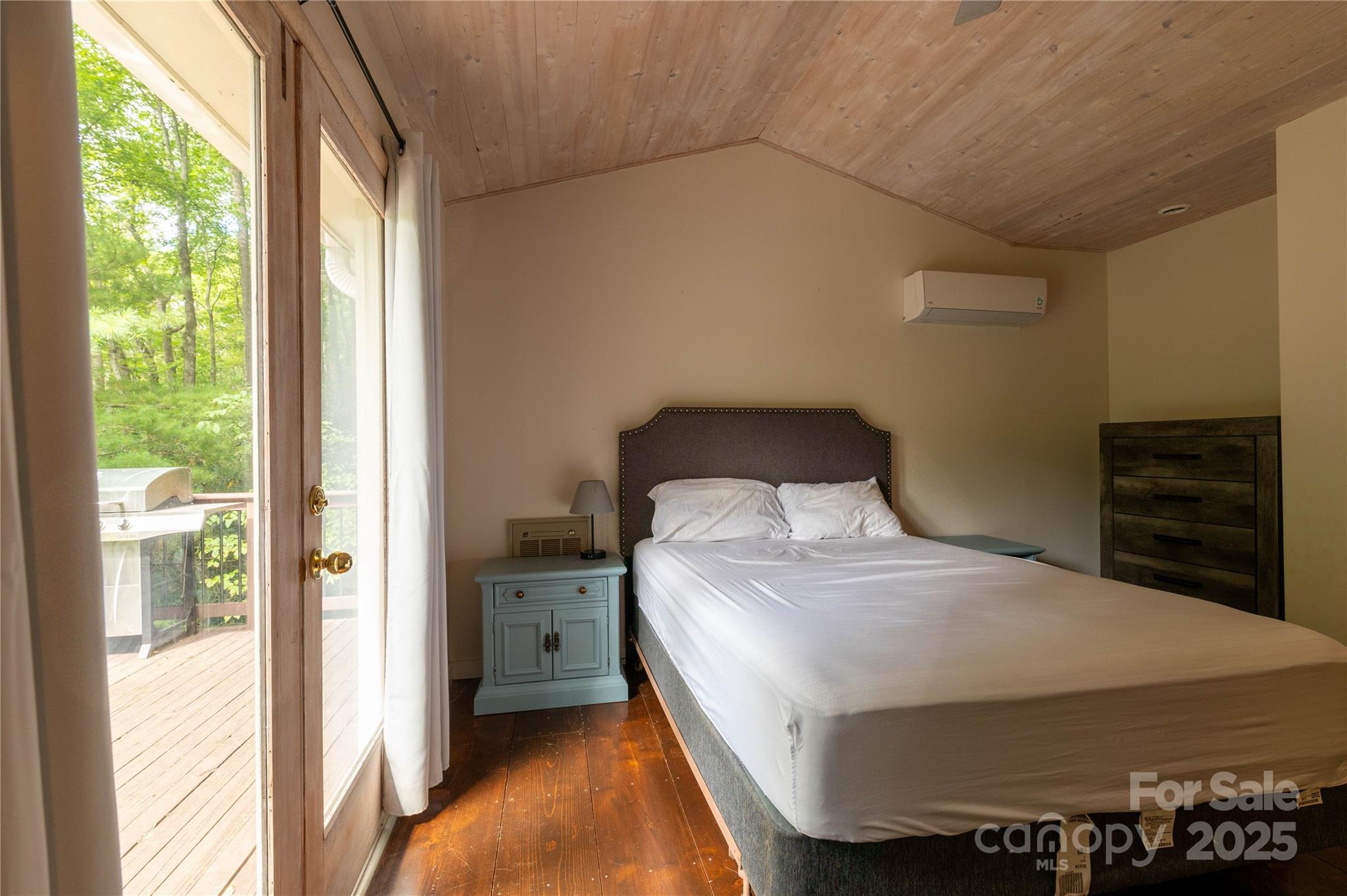 479 Big Ridge Road Burnsville, NC 28714 - Photo 21 of 40 a bedroom with a bed and a window