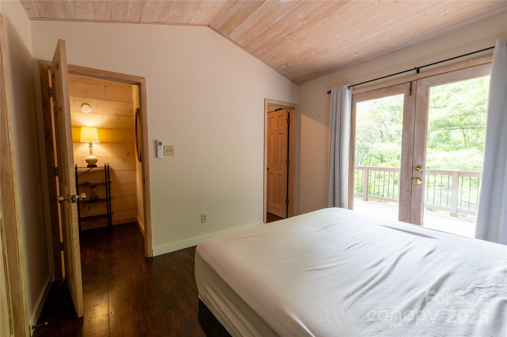 479 Big Ridge Road Burnsville, NC 28714 - Photo 22 of 40 a bedroom with a bed and a large window