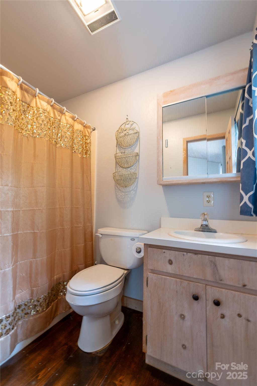 479 Big Ridge Road Burnsville, NC 28714 - Photo 23 of 40 a bathroom with a toilet a sink and a mirror