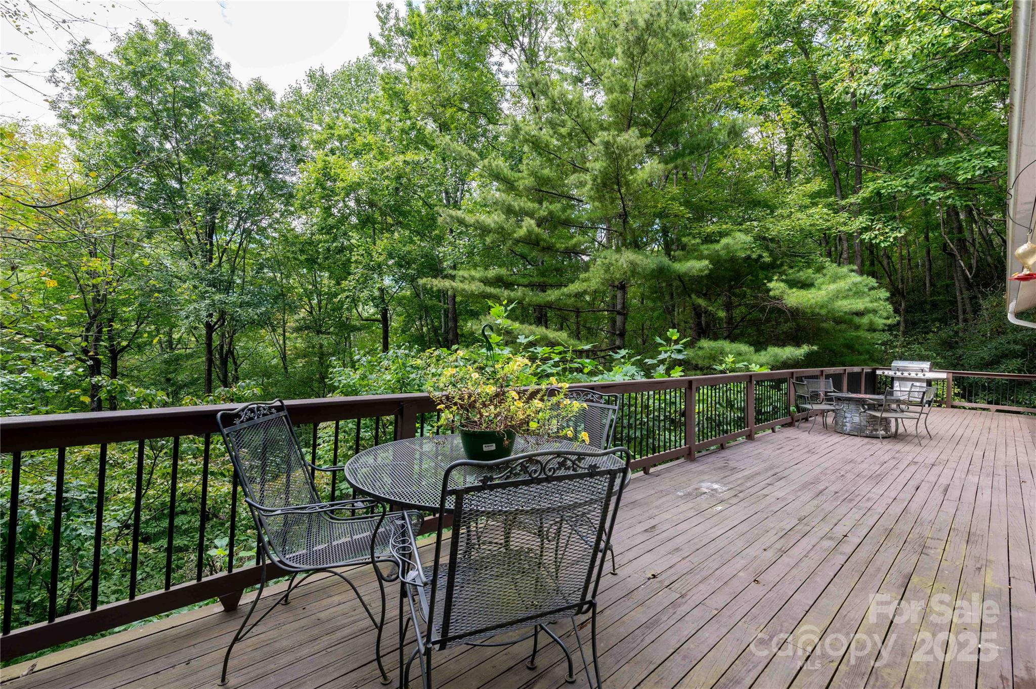 479 Big Ridge Road Burnsville, NC 28714 - Photo 24 of 40 a view of a chairs and table on the wooden deck