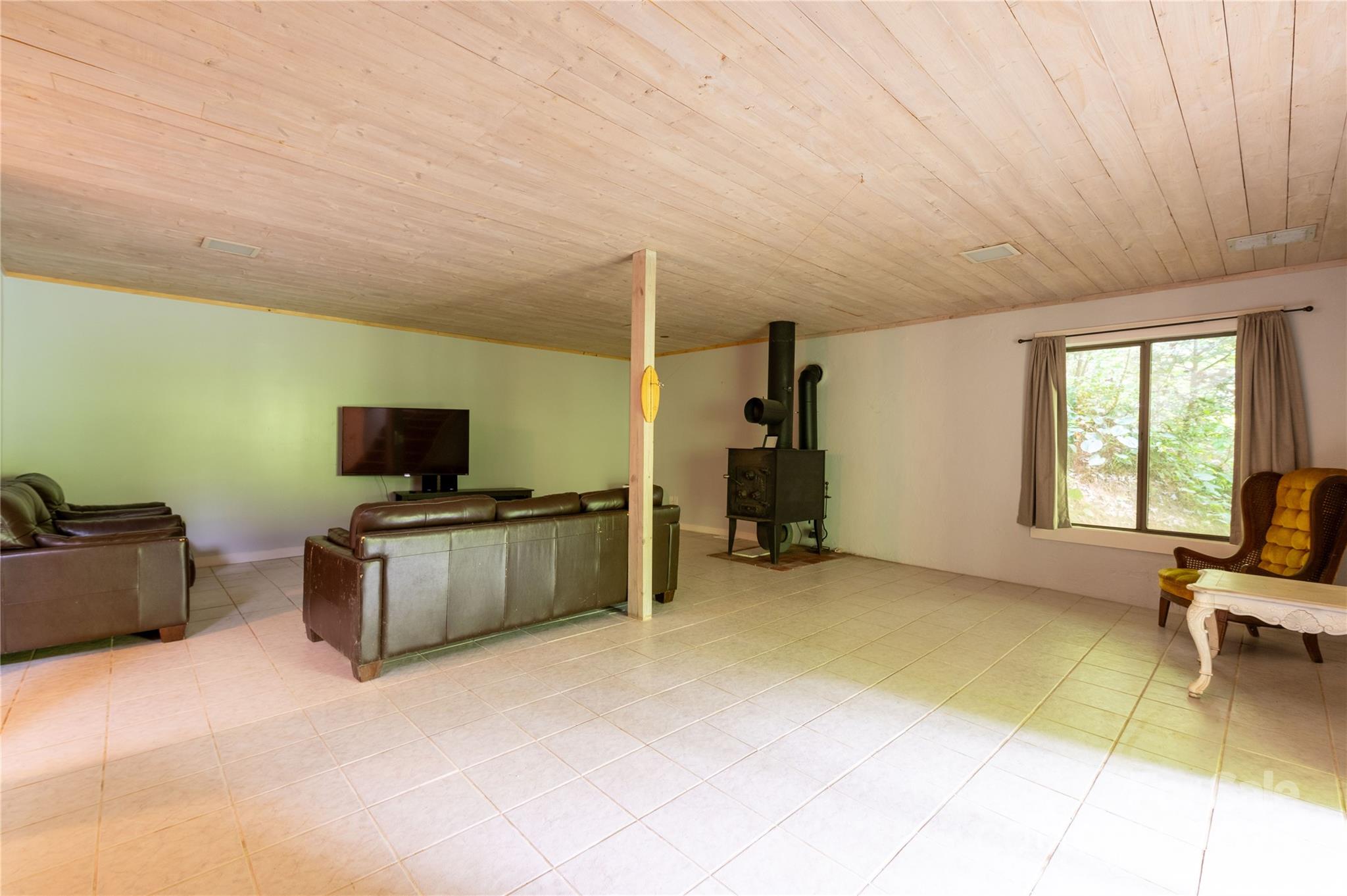 479 Big Ridge Road Burnsville, NC 28714 - Photo 28 of 40 a living room with furniture and a flat screen tv