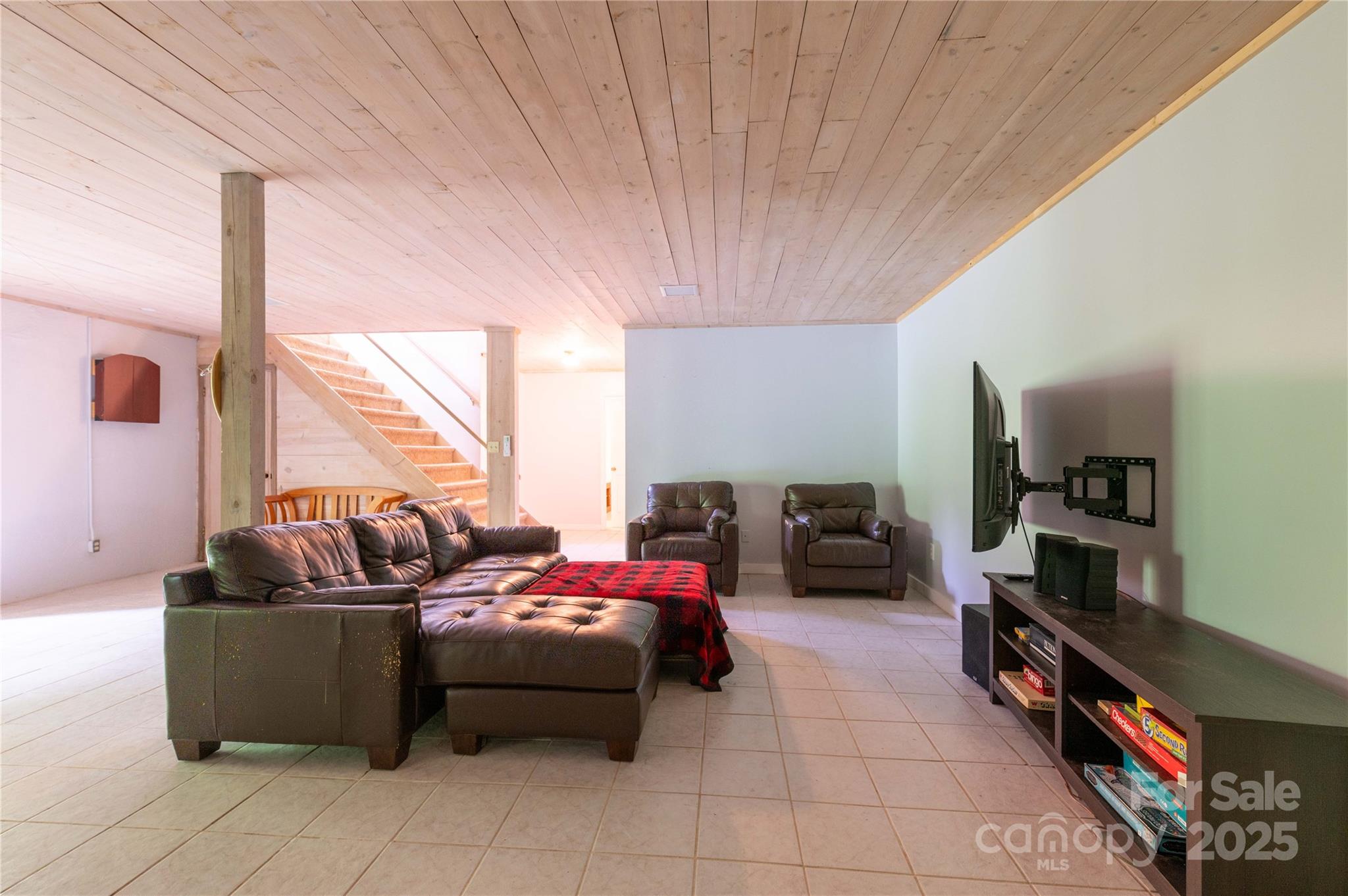 479 Big Ridge Road Burnsville, NC 28714 - Photo 29 of 40 a living room with furniture a flat screen tv and a large window