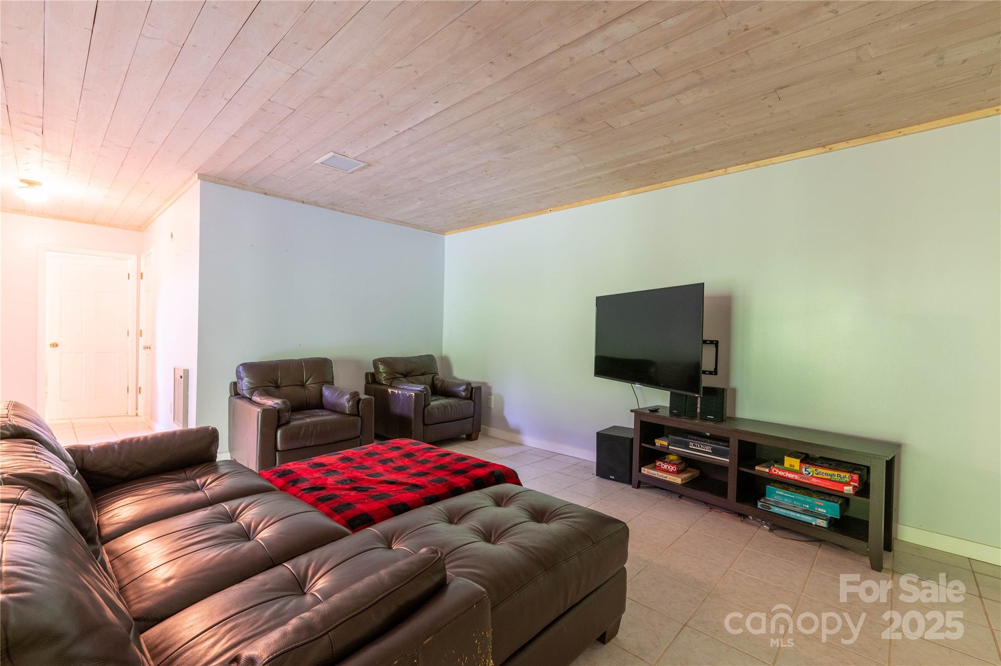 479 Big Ridge Road Burnsville, NC 28714 - Photo 30 of 40 a living room with furniture and a flat screen tv
