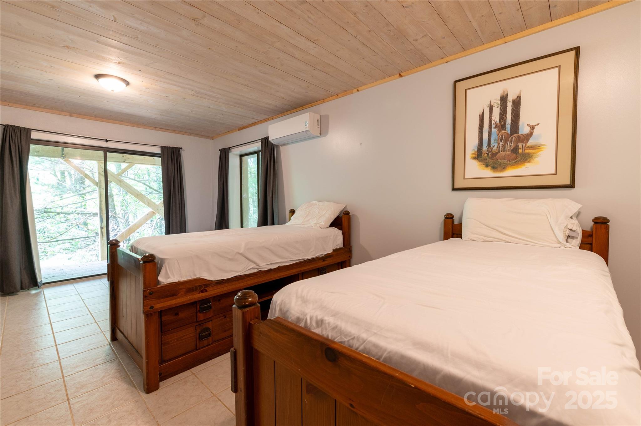 479 Big Ridge Road Burnsville, NC 28714 - Photo 33 of 40 a spacious bedroom with two beds and a large window