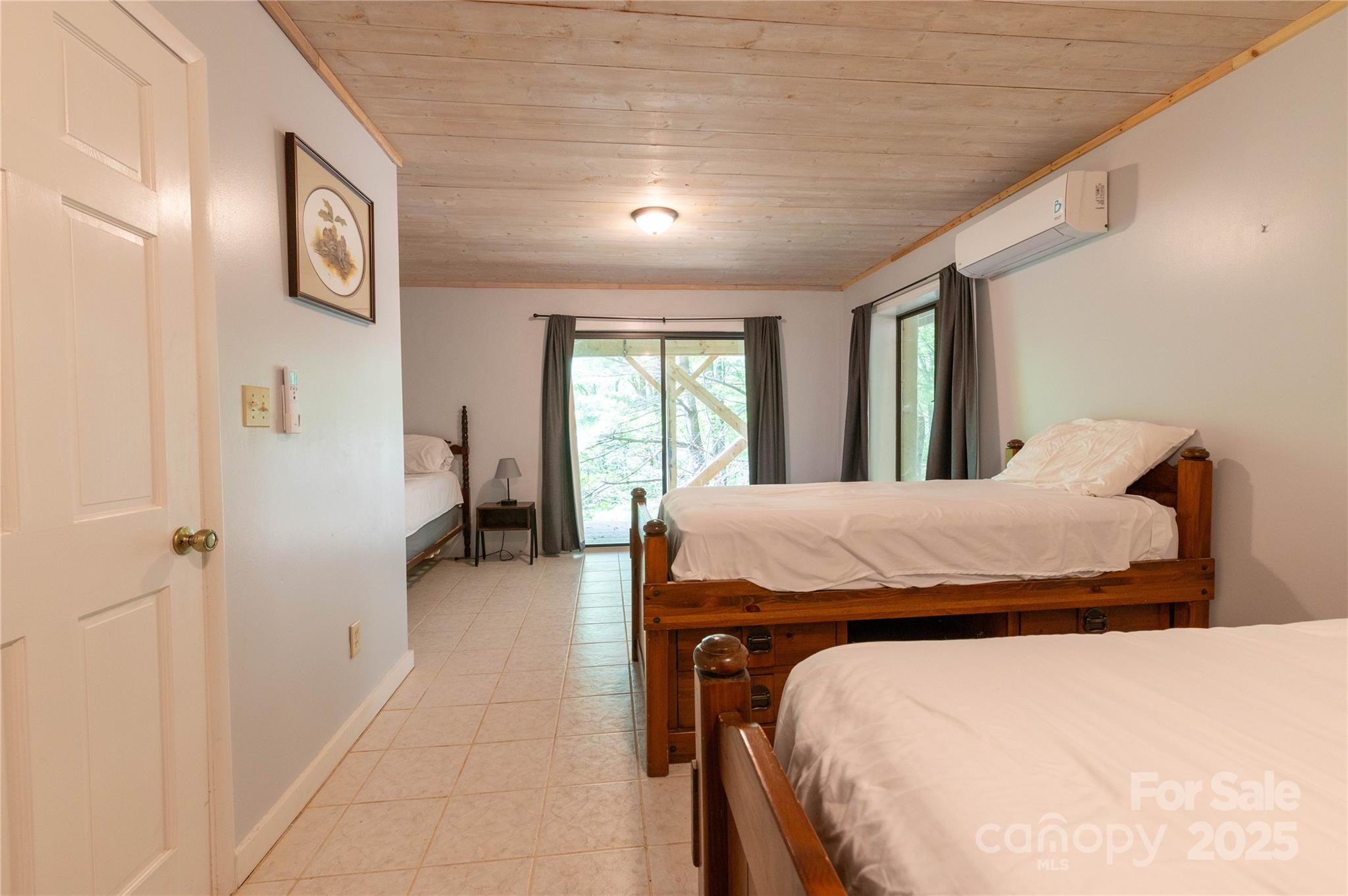 479 Big Ridge Road Burnsville, NC 28714 - Photo 34 of 40 a bed sitting in a spacious bedroom next to a window