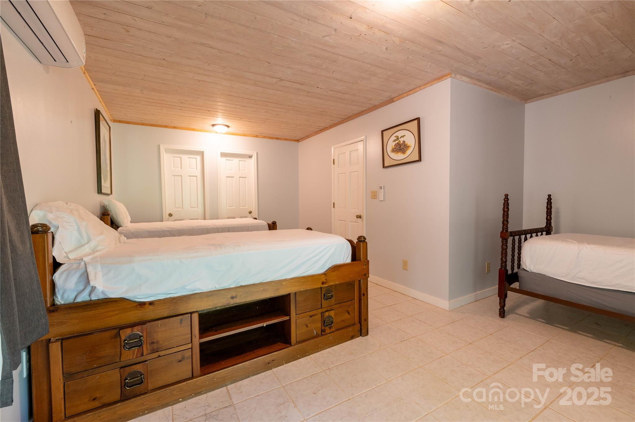 479 Big Ridge Road Burnsville, NC 28714 - Photo 35 of 40 a spacious bedroom with a bed and a dresser