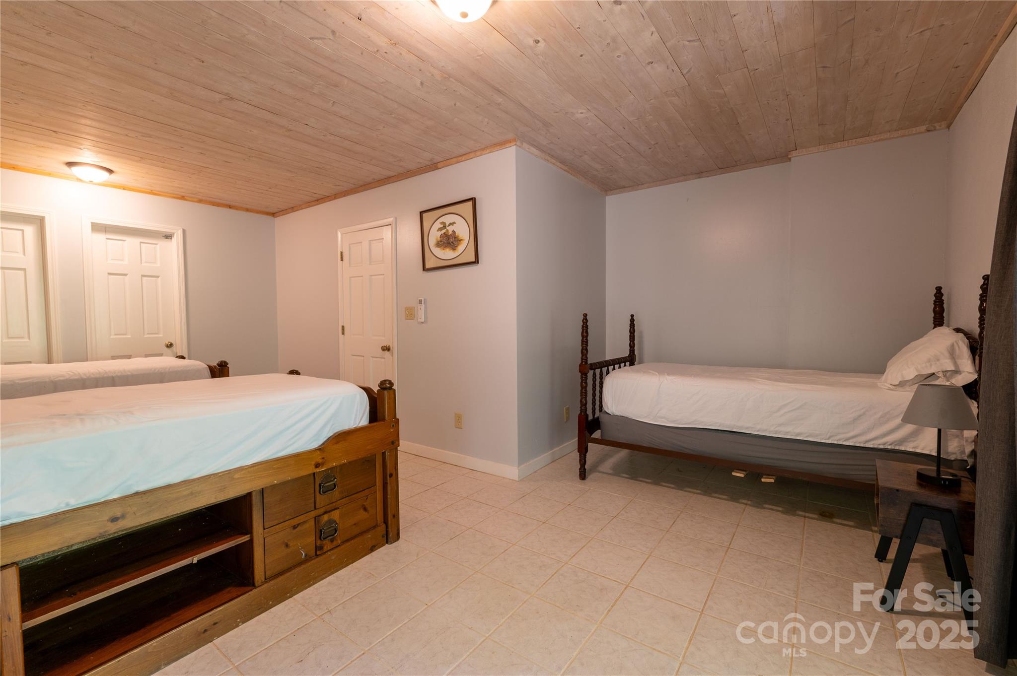 479 Big Ridge Road Burnsville, NC 28714 - Photo 36 of 40 a spacious bedroom with a bed and a cabinets