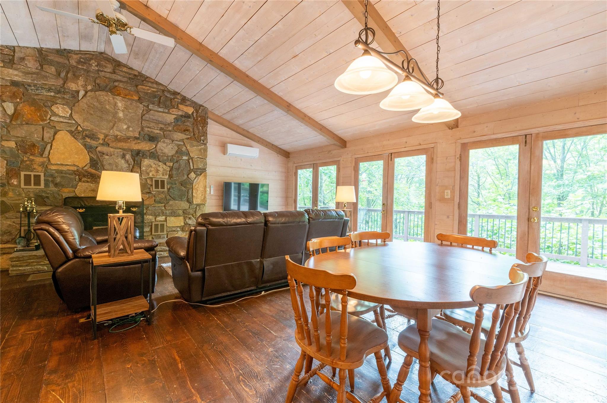 479 Big Ridge Road Burnsville, NC 28714 - Photo 7 of 40 a dining room with wooden floor and large windows