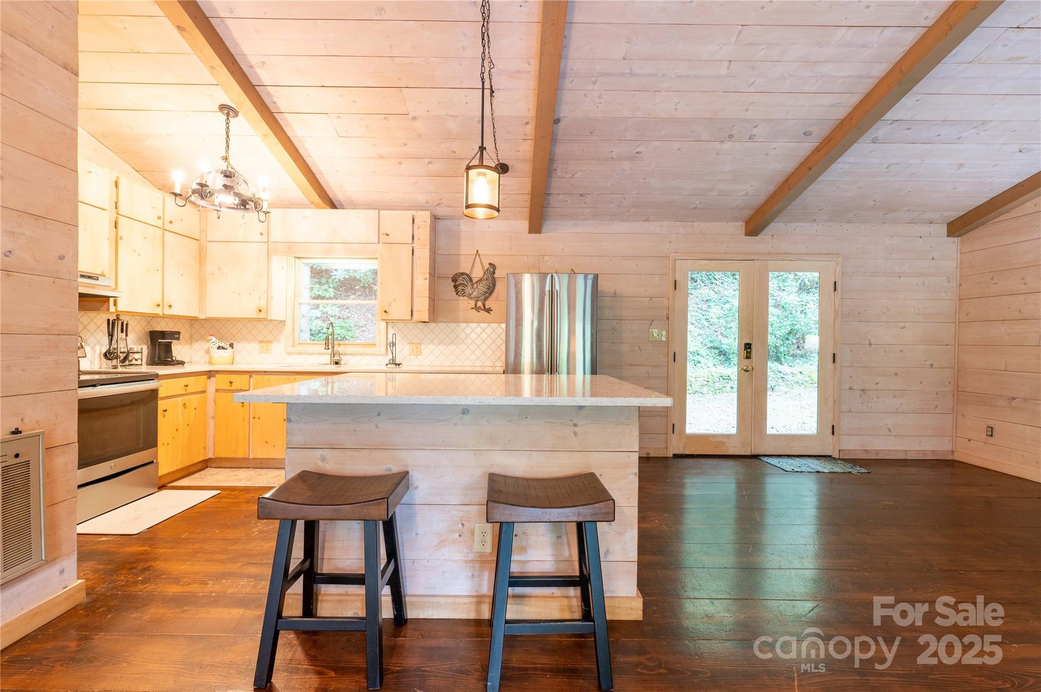 479 Big Ridge Road Burnsville, NC 28714 - Photo 9 of 40 a kitchen with a table chairs sink and cabinets