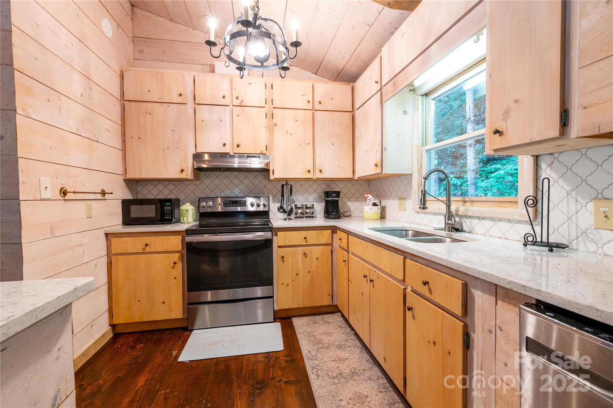 479 Big Ridge Road Burnsville, NC 28714 - Photo 10 of 40 a kitchen with stainless steel appliances granite countertop a sink a stove and cabinets
