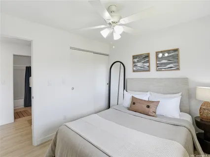 a bedroom with a large bed and a chandelier