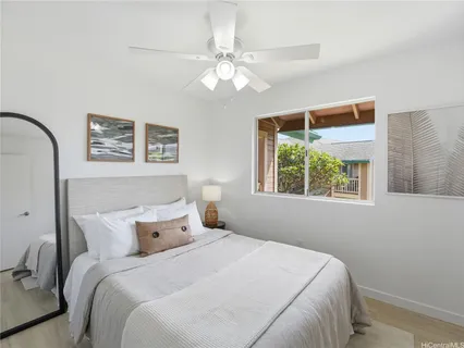 a bedroom with a large bed and a window