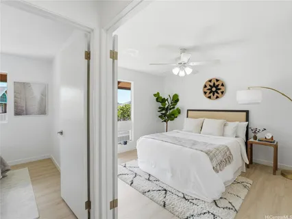a bedroom with a large bed and a chandelier
