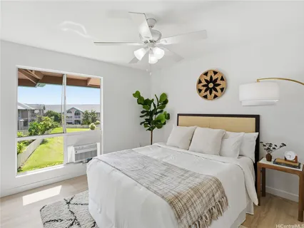 a bedroom with a bed and a large window